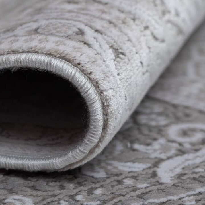 Close-up of a rolled-up gray textured rug